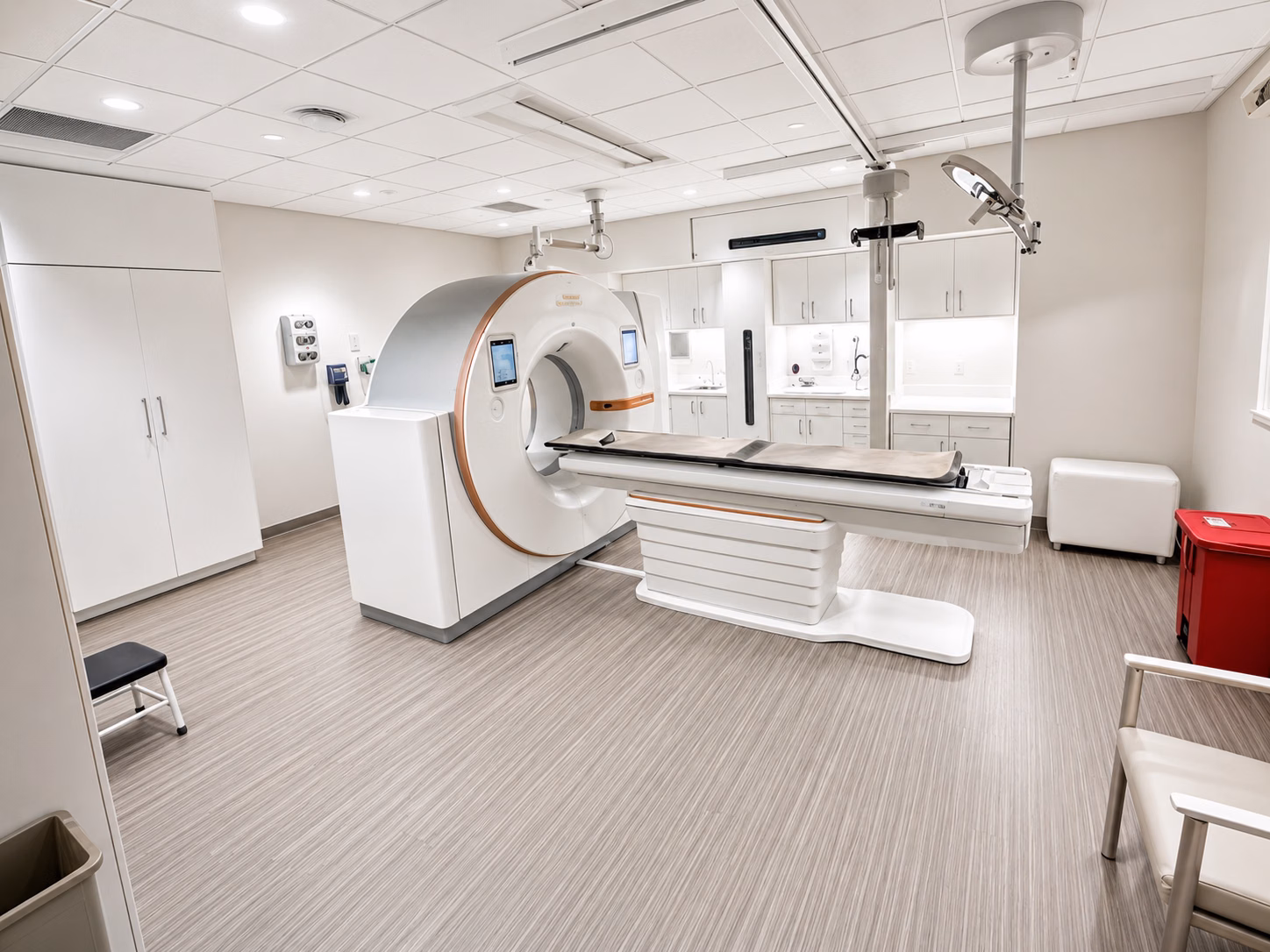 Exam room handed over after renovation, with casework, fixtures, and resilient flooring finished.
